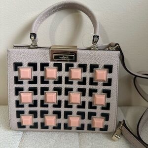 kate spade beige satchel with black trim and pink studs